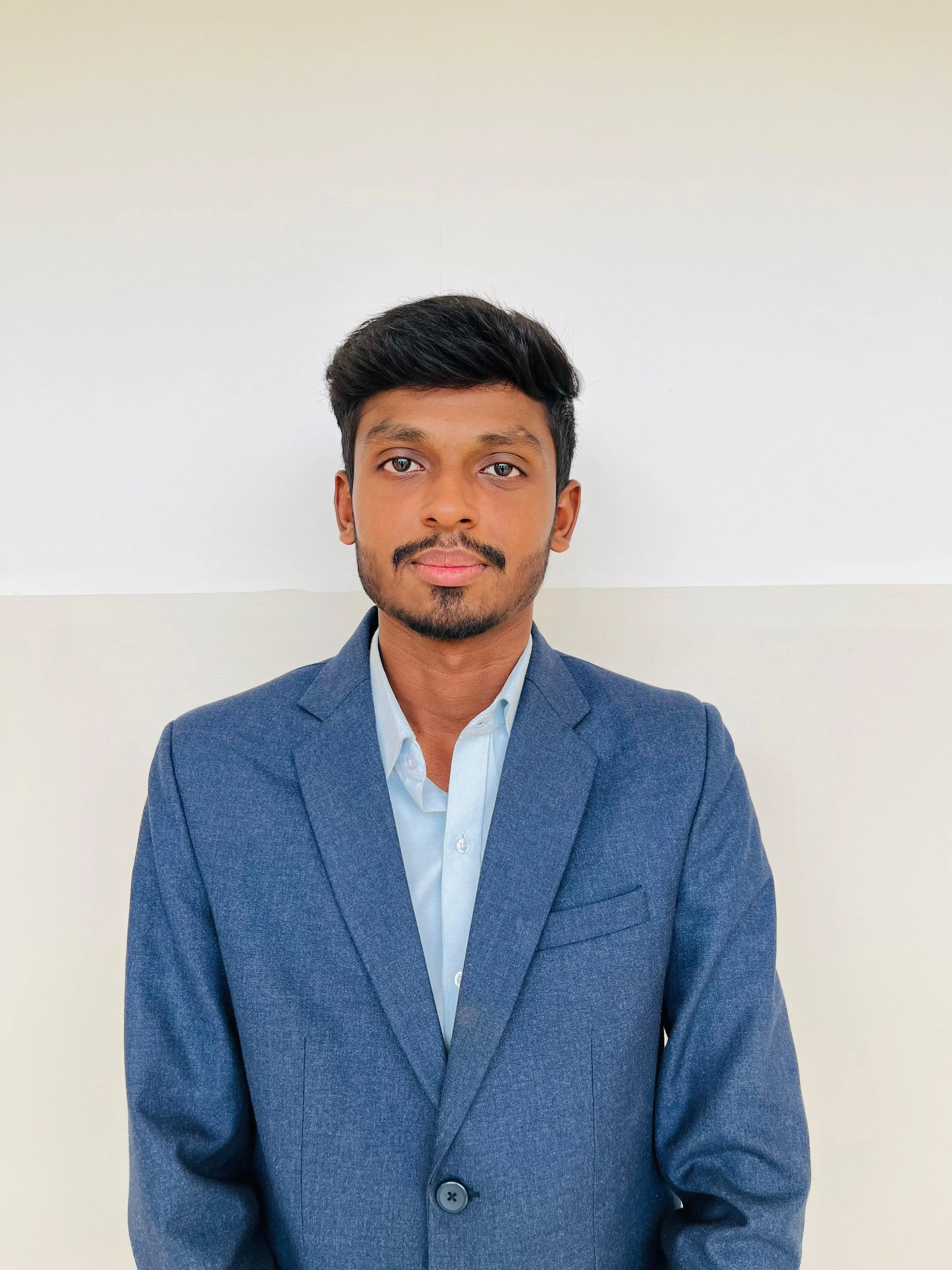 Portrait of smiling young man Richard Lock with orange background